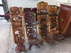 Description 126 - Collection of four Folding African Carved Chairs